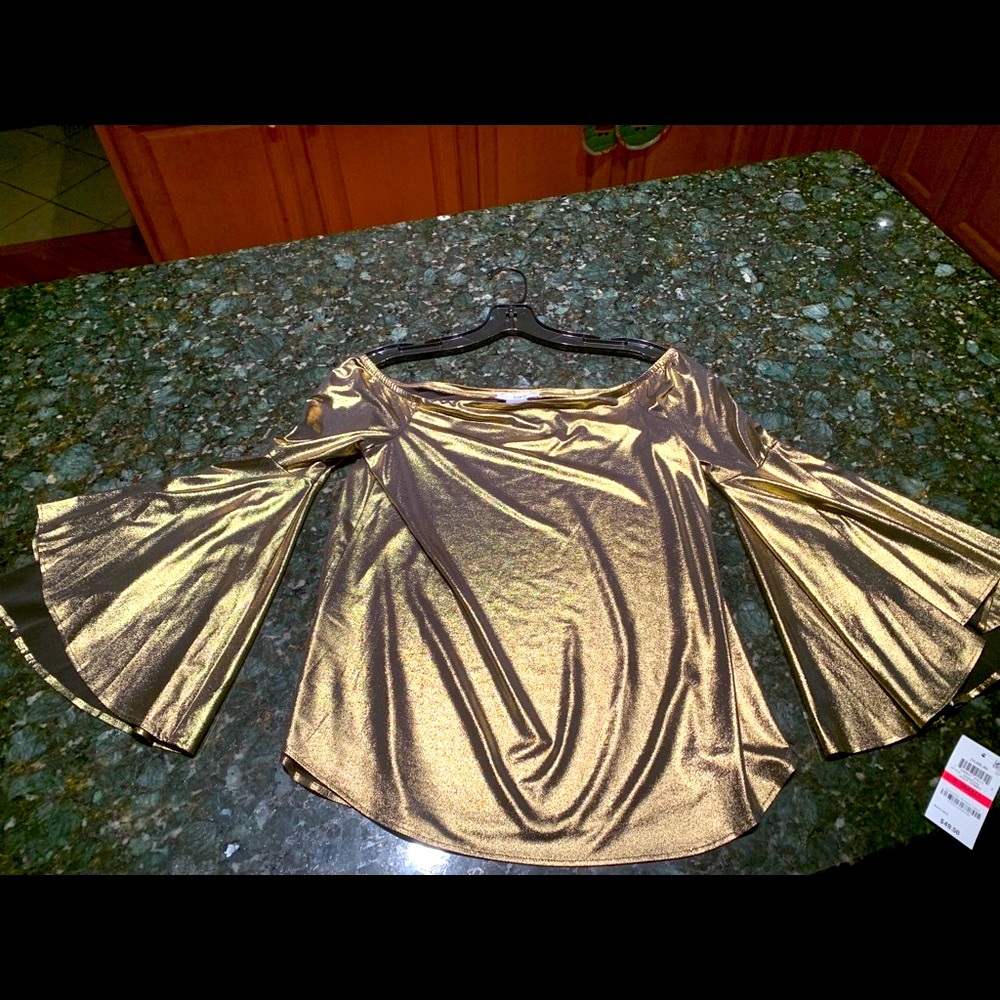 A gorgeous off-the-shoulder gold blouse.